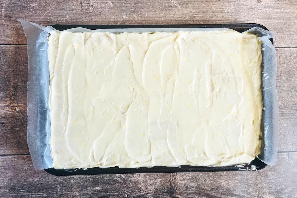 Frosted graham wafer lemon bars on cookie sheet.