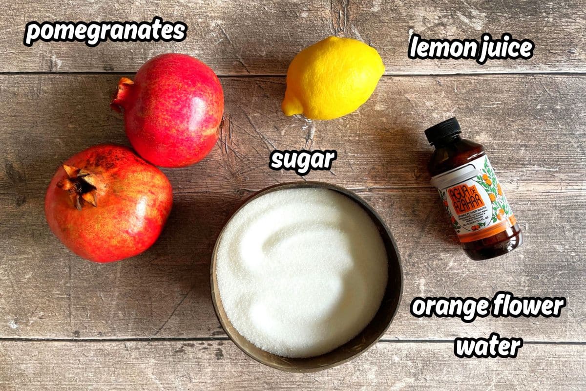 Grenadine syrup ingredients labeled on wooden background.