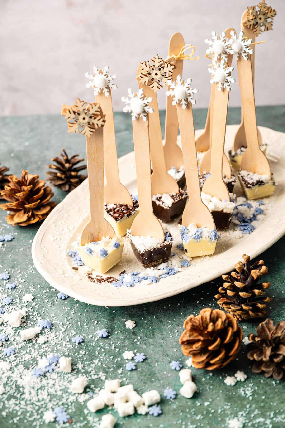 Hot chocolate spoons on white serving tray.