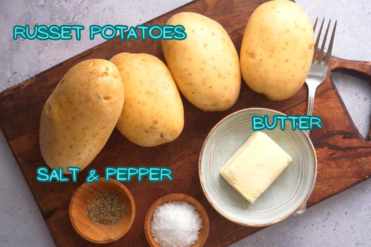 Baked potatoes ingredients prepped on wooden board and labeled.