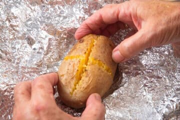 Baked Yukon gold potato on foil.