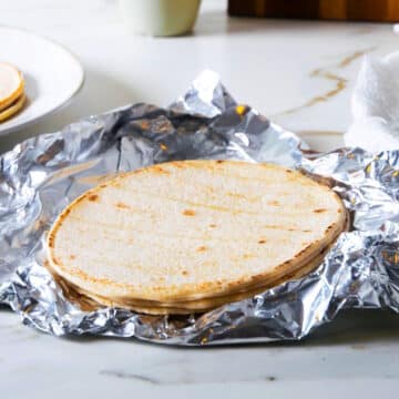 Corn tortillas on foil.