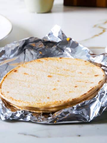 Corn tortillas on foil.