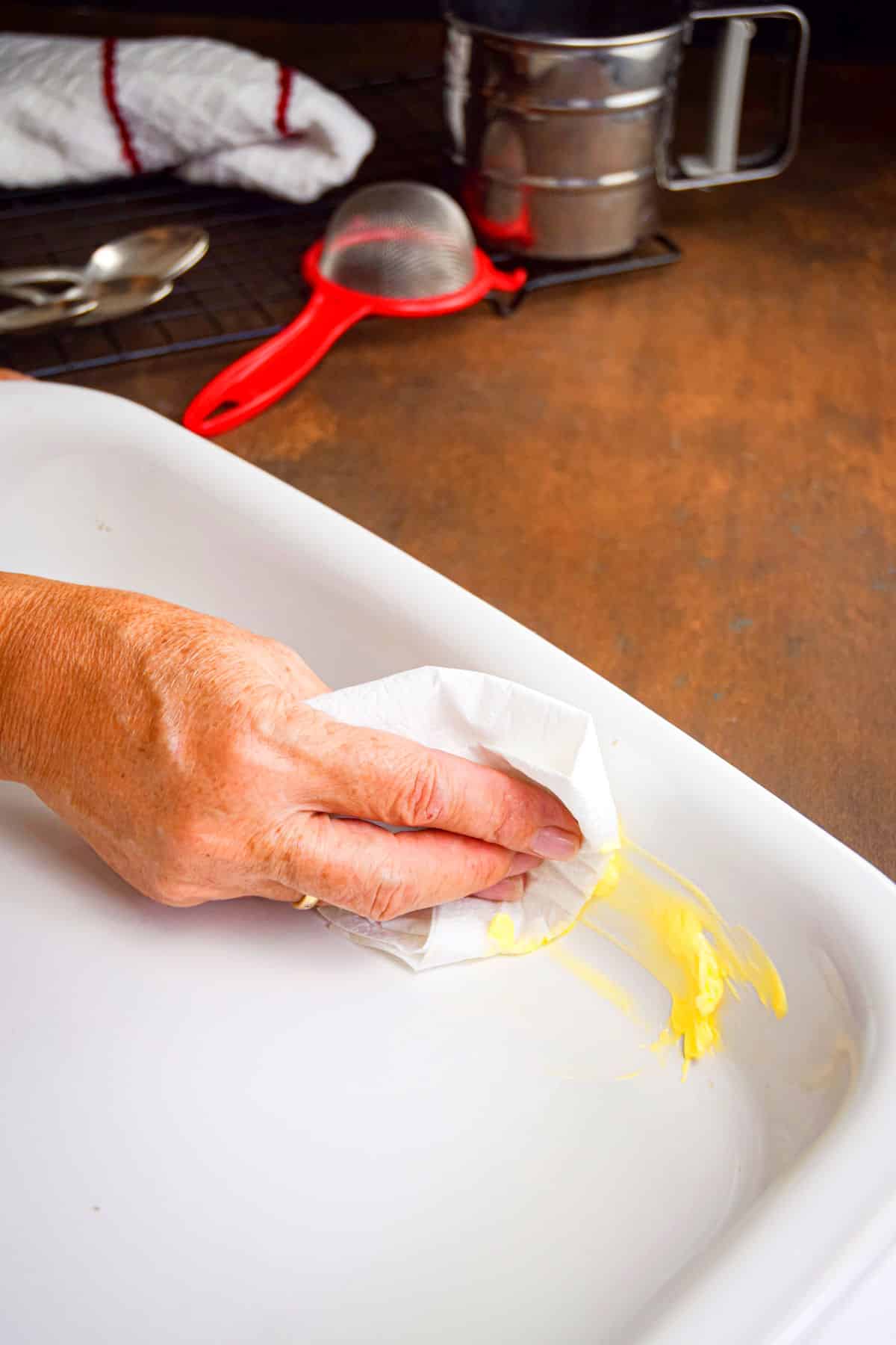 Jelly roll pan getting buttered.