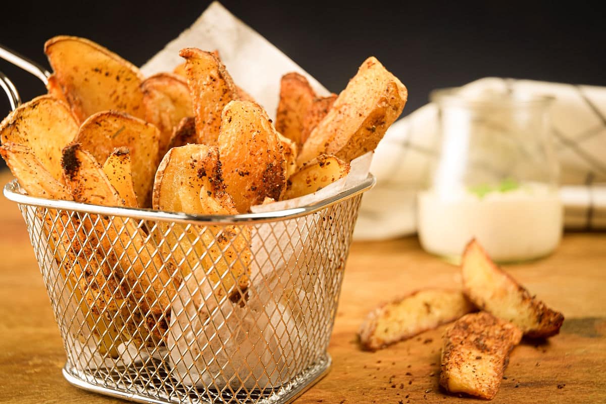 Cajun seasoned fries in basket.