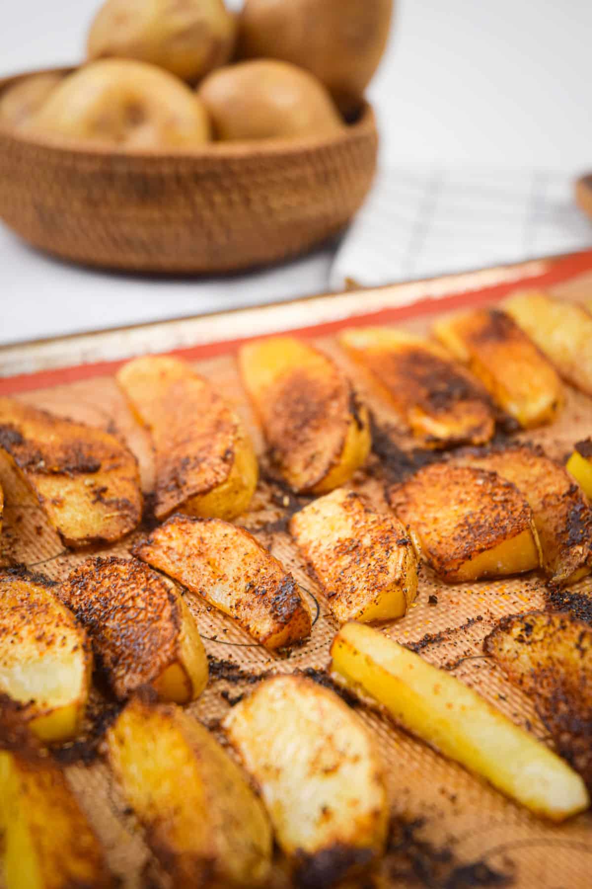 Oven baked Cajun fries on baking sheet.