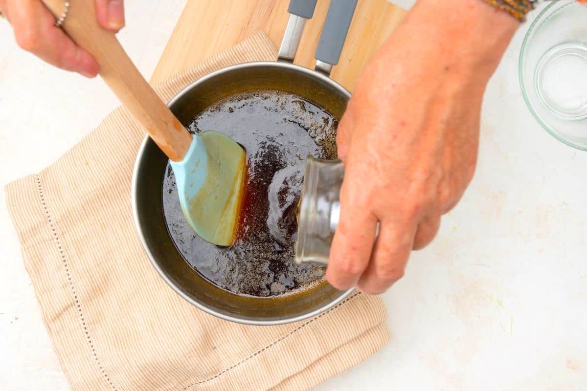 Caramel syrup in pot with caramel extract.