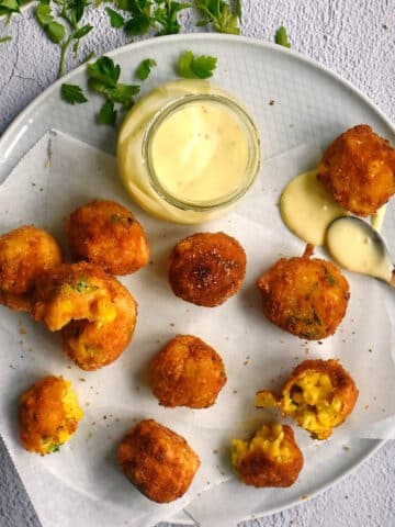 Corn nuggets on plate with dip.