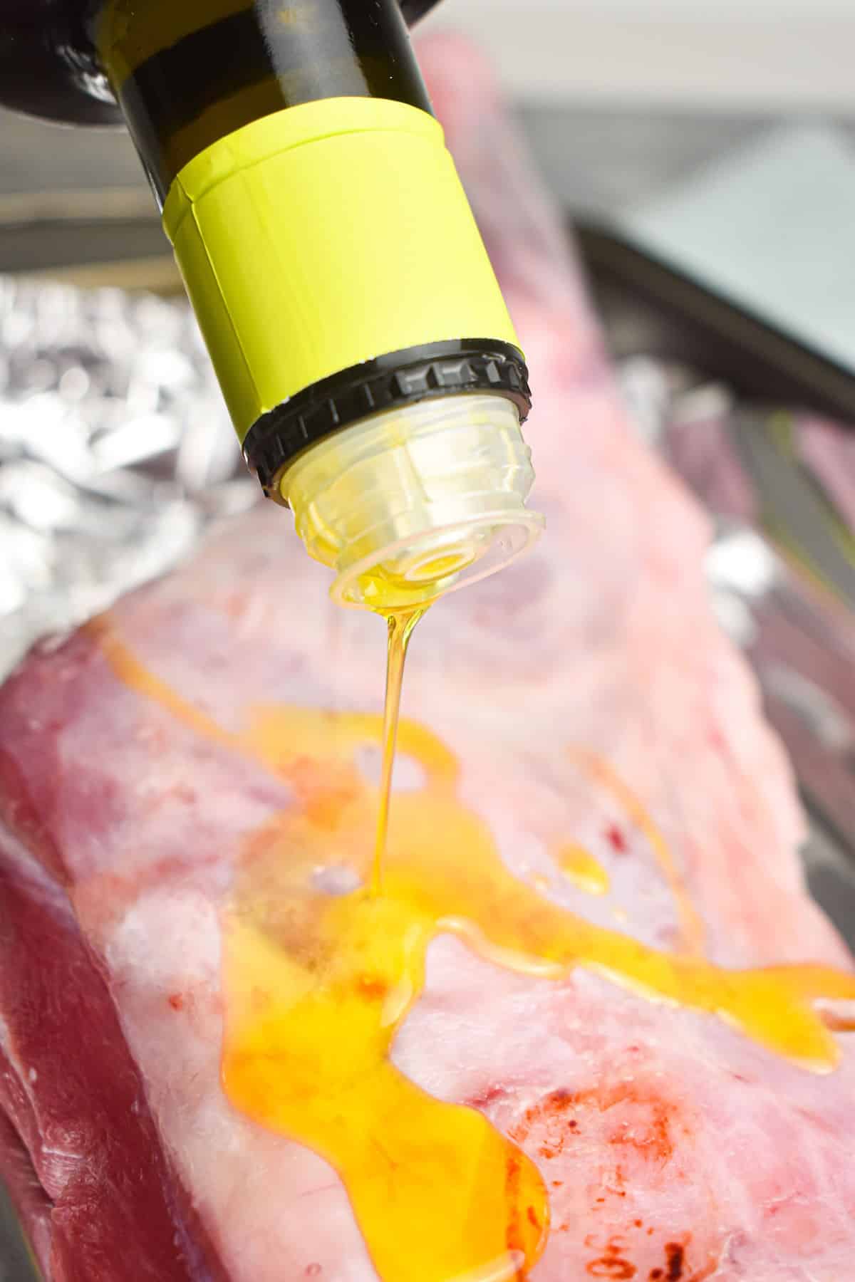 Raw lamb shoulder drizzled with olive oil.