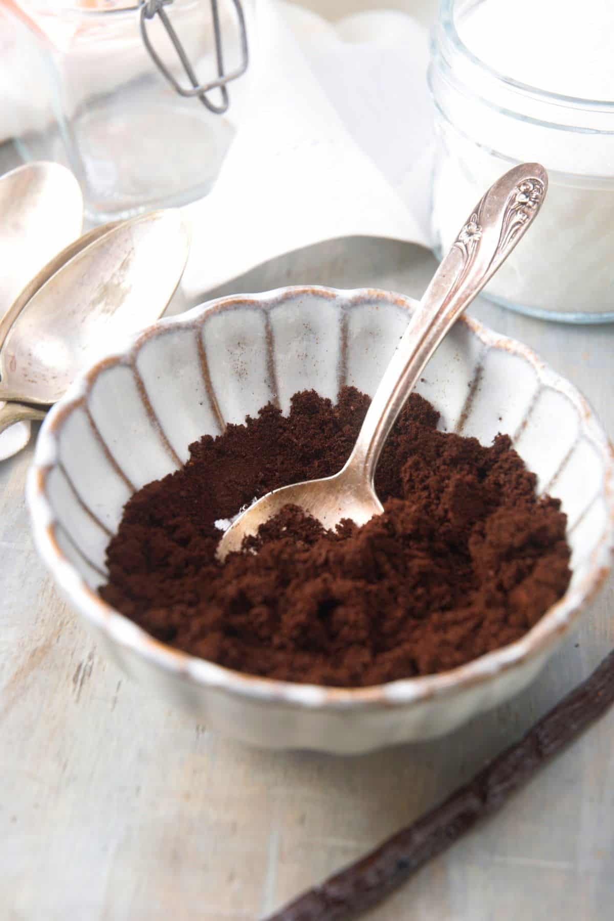 Vanilla bean powder in bowl with spoon.