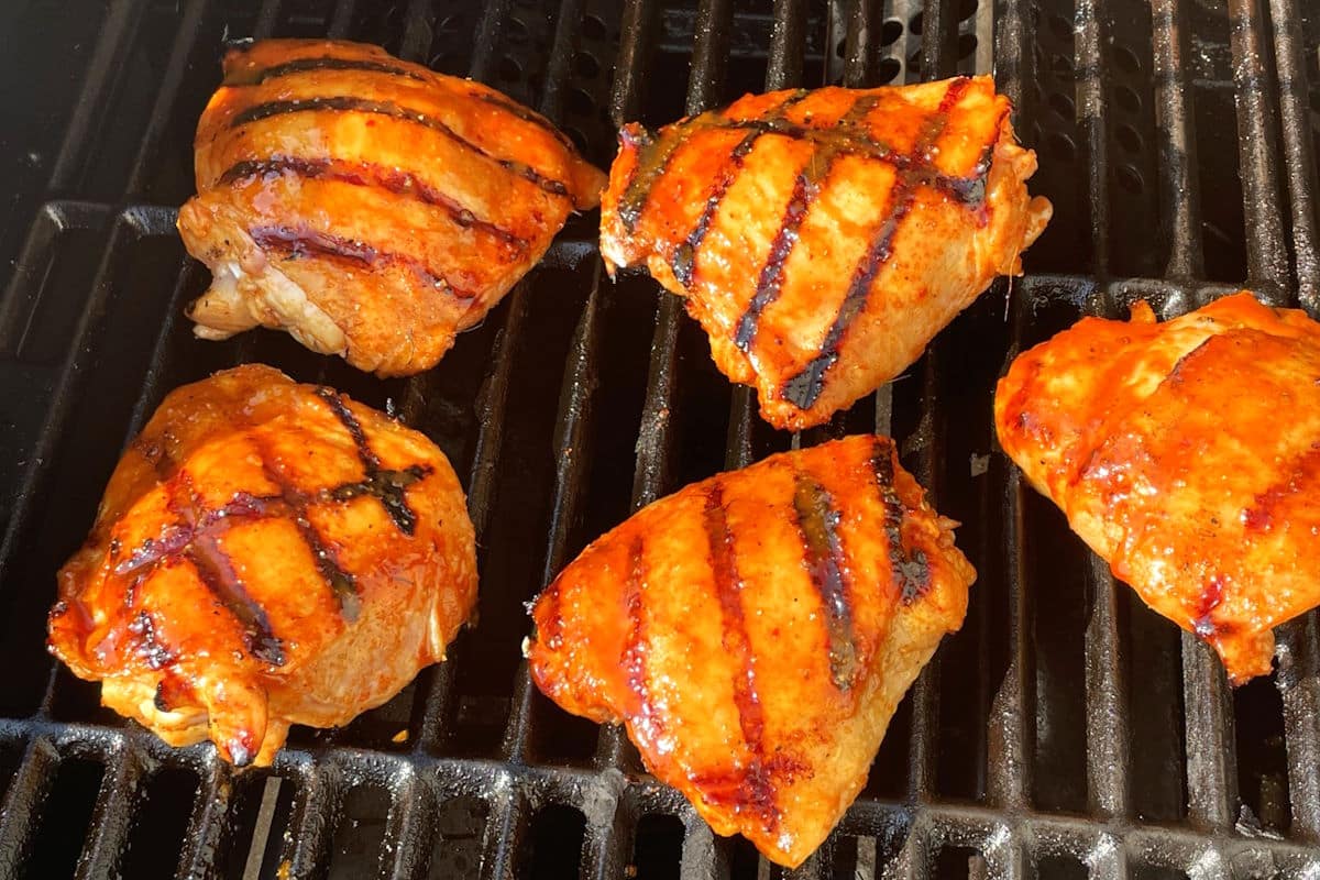 Kimchi chicken on the grill, basted in kimchi sauce.