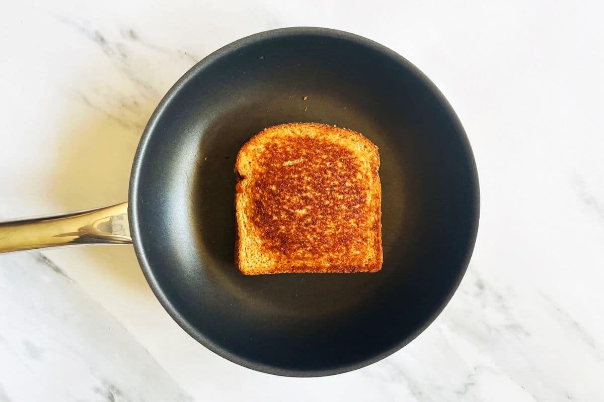 Kimchi grilled cheese sandwich in pan.