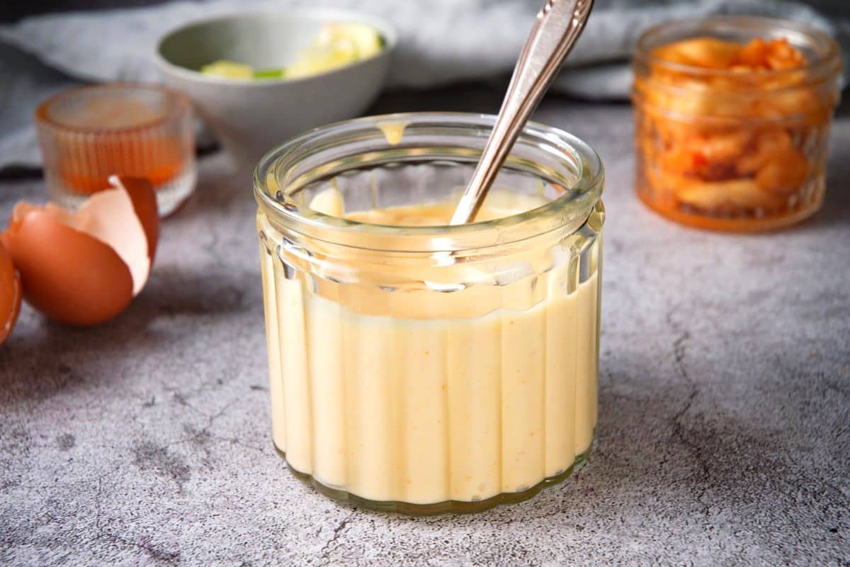 Homemade mayo in jar with spoon.