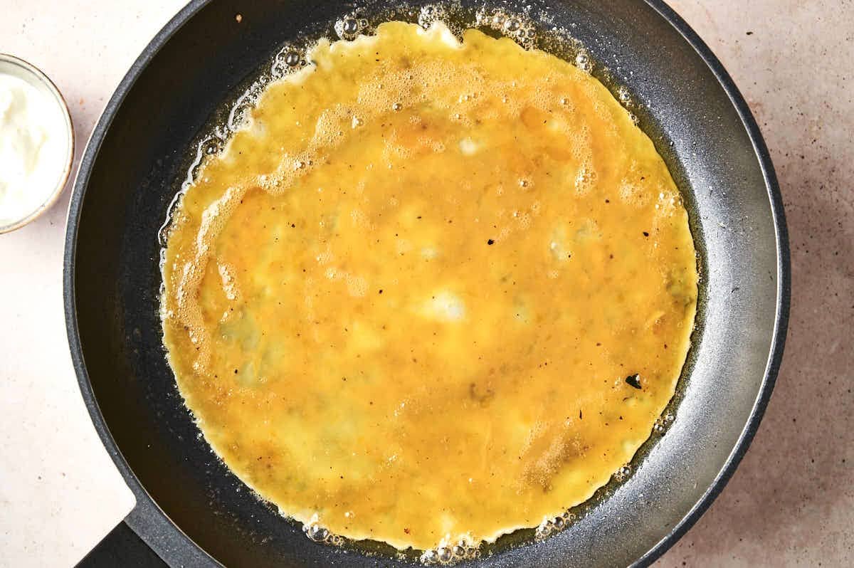 Eggs cooking in pan.