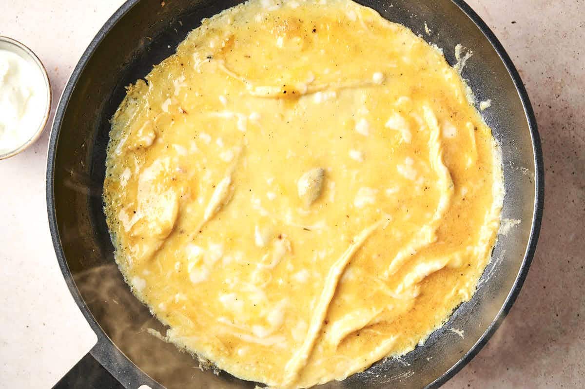Omelette cooking in pan.