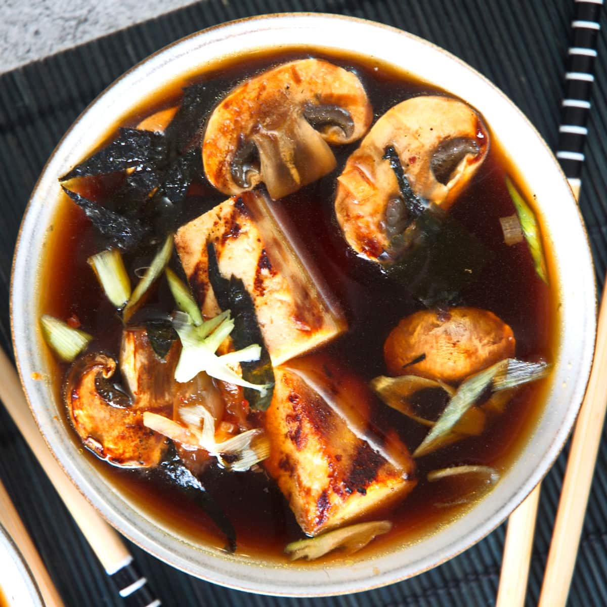 Kimchi tofu vegan soup in white bowl.