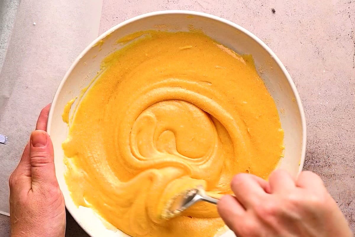 Cheese powder mixture in bowl with spoon.