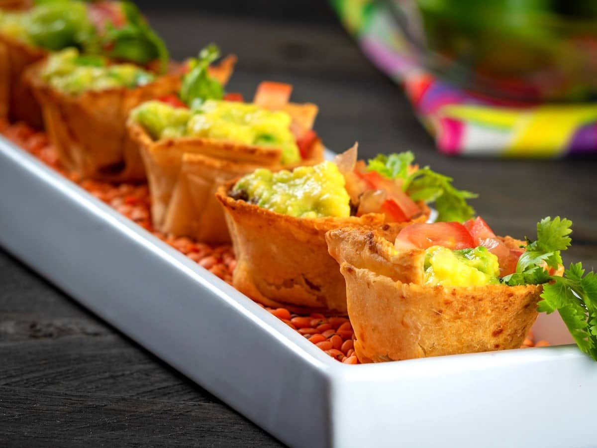 Baked taco cups in white dish.