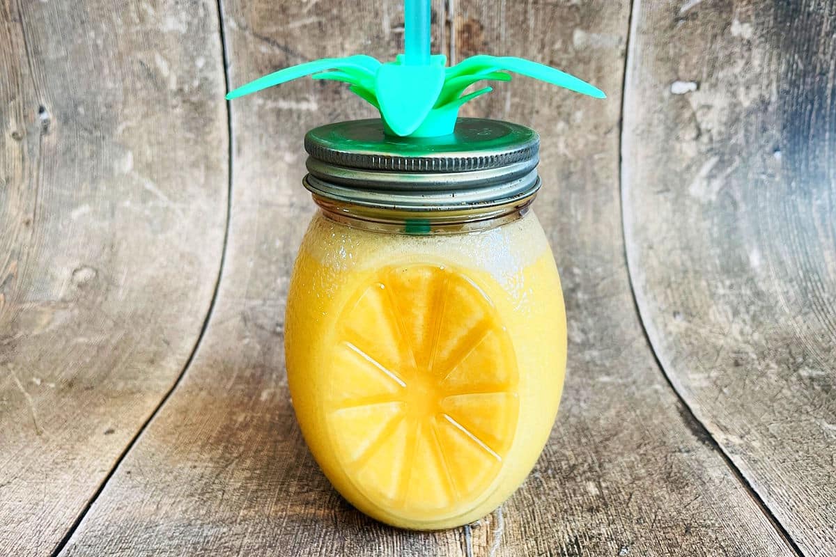 Orange Julius in glass on wooden background.