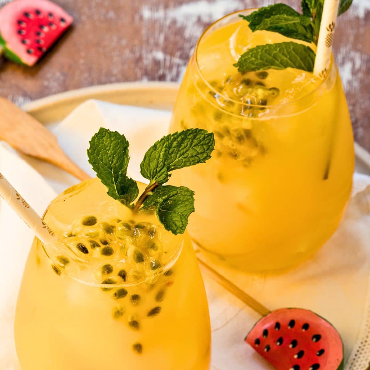 Passion fruit mojitos with fresh mint in glasses.