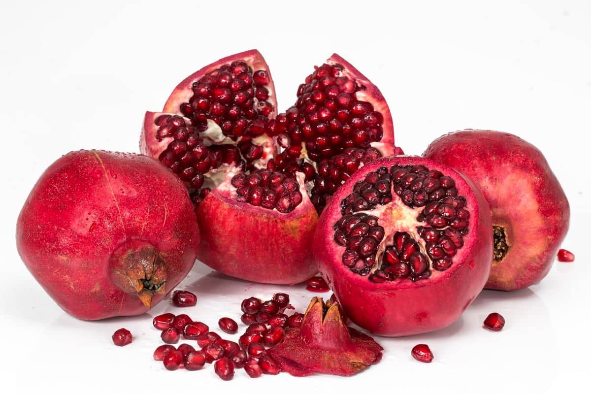 Pomegranates, whole and cut open. isolated on white background.