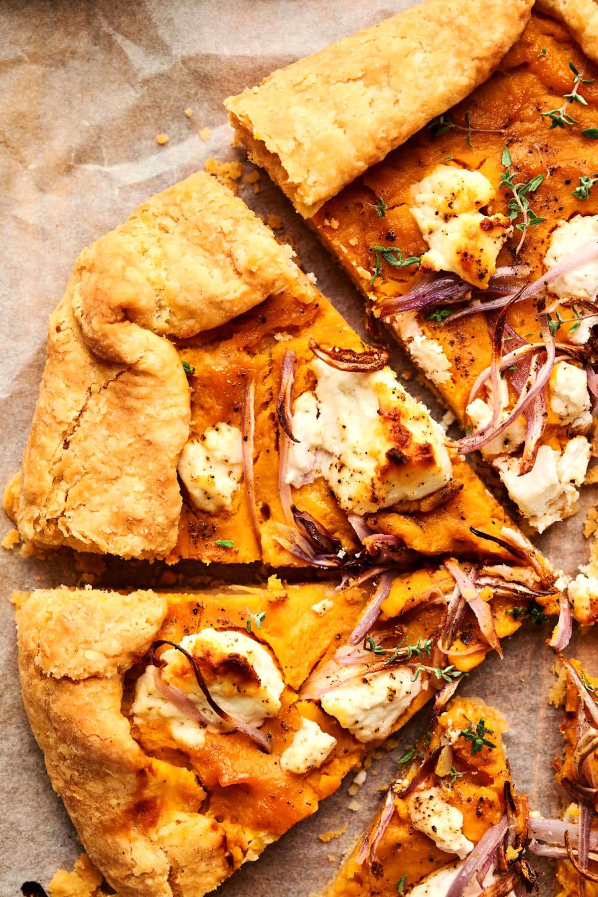 Sliced pumpkin galette on parchment.