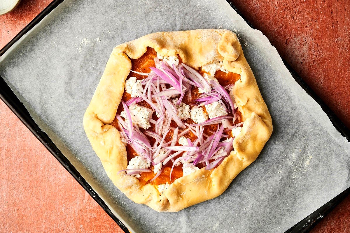 Unbaked pumpkin galette on sheet pan.