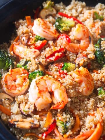 Quinoa stir fry in skillet.