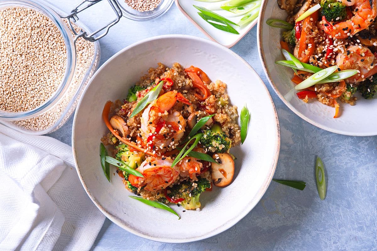 Quinoa stir fry with shrimp in bowls.