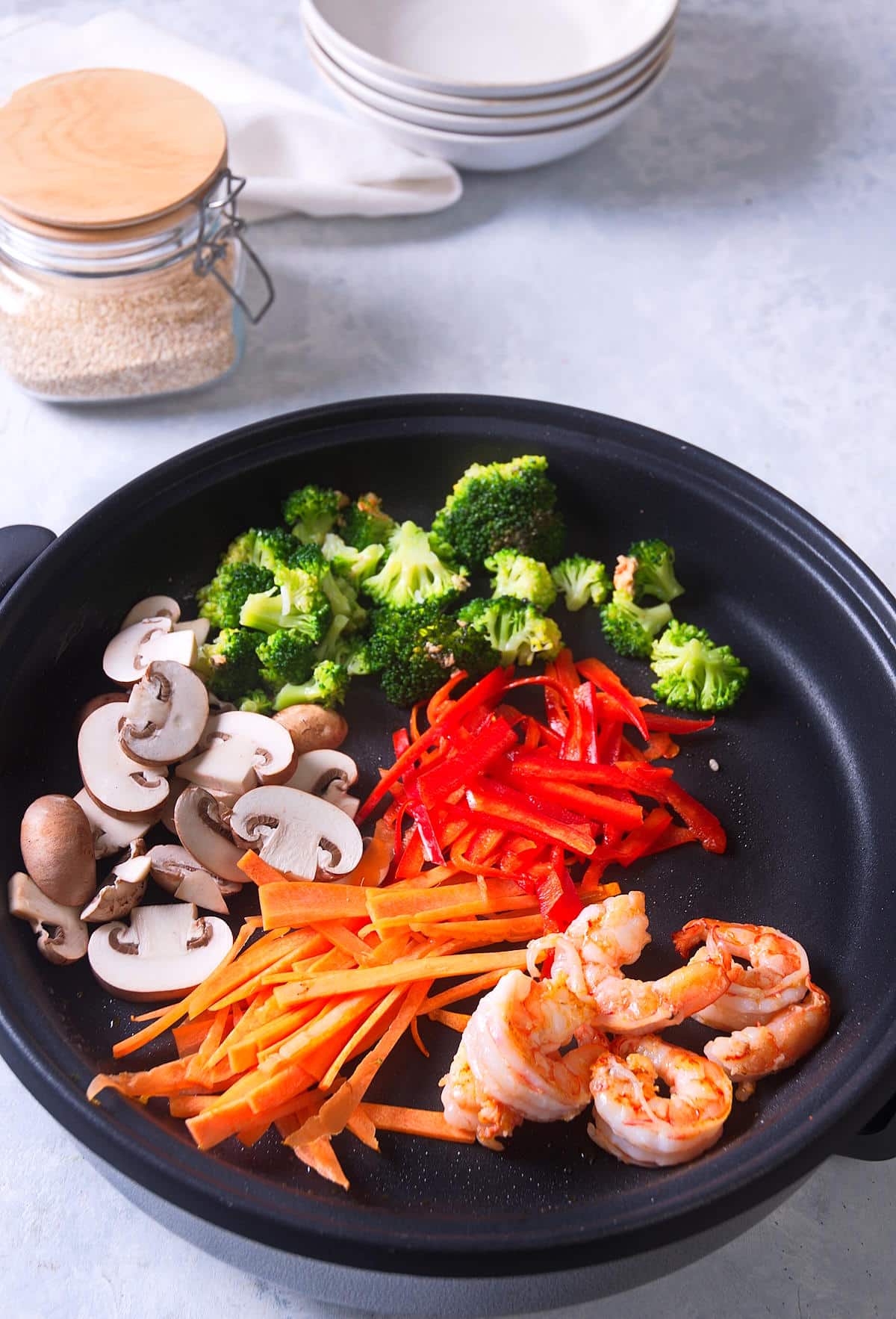 Shrimp and veggies in skillet.
