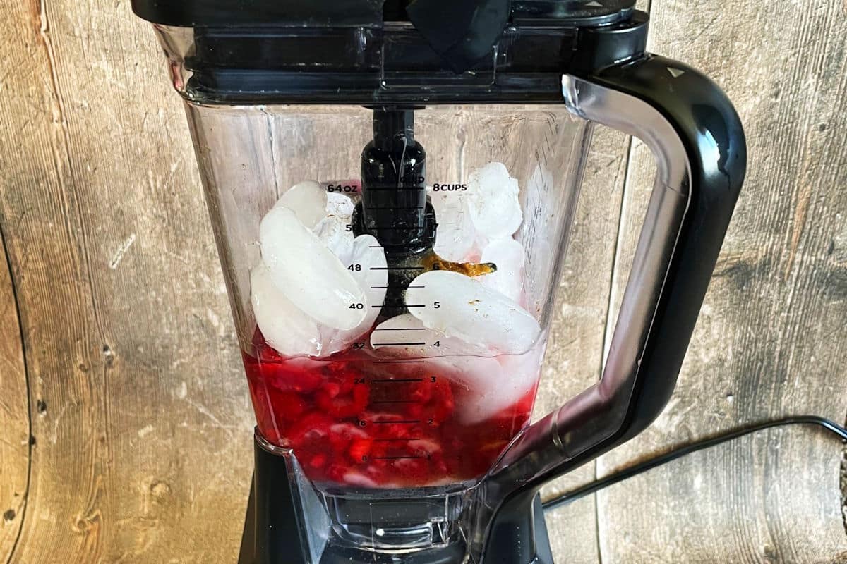 Raspberry cocktail ingredients in blender.