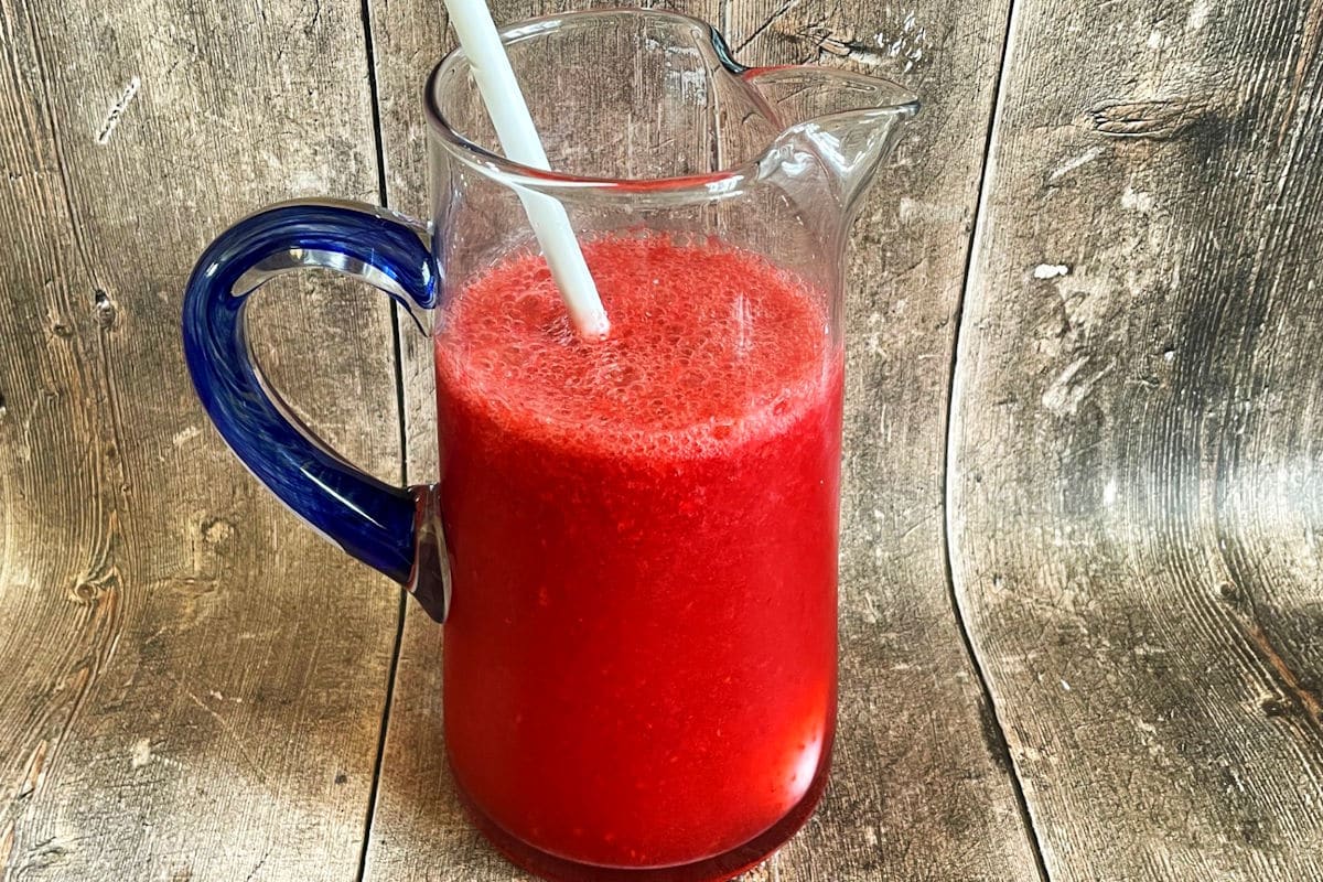 Raspberry cocktail in pitcher.