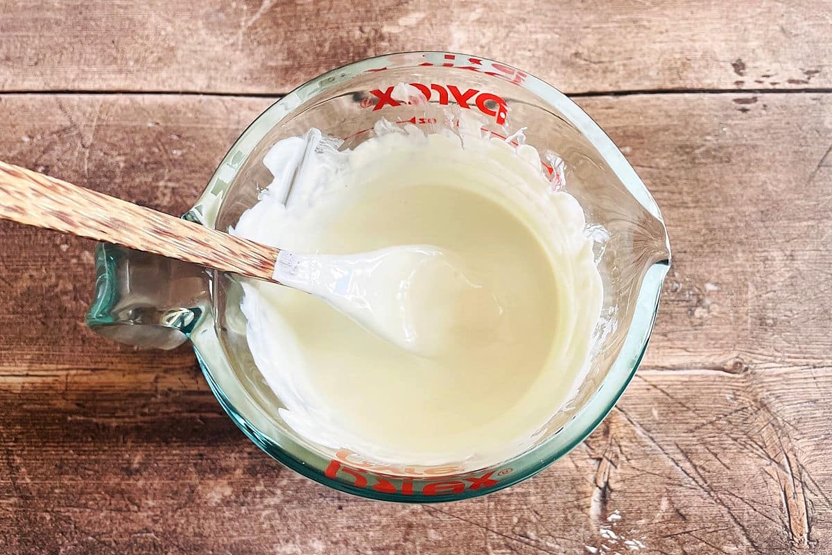 White candy melt coating melted in glass measuring cup.