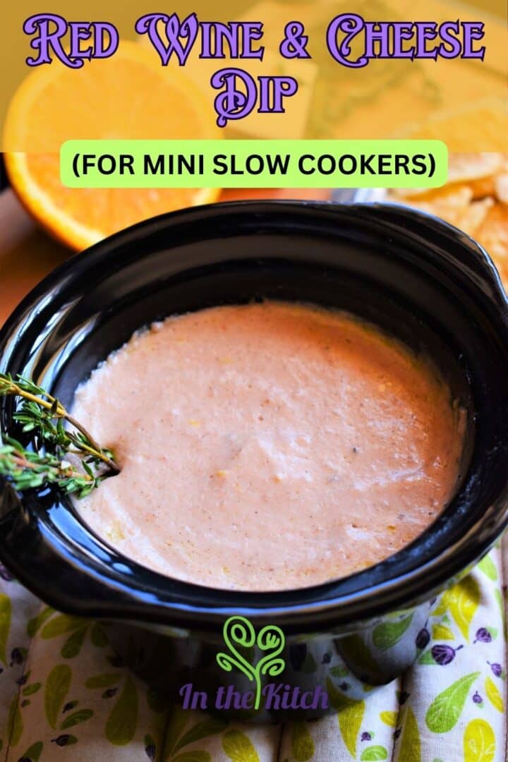 Red wine cheese dip in mini slow cooker on pot holder.