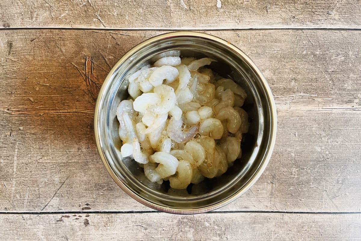 Raw shrimp with egg whites in bowl.