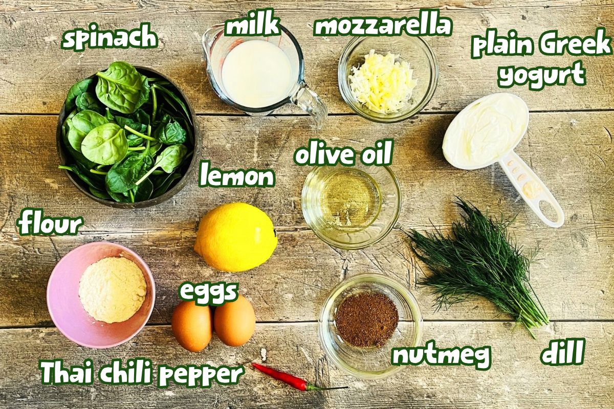 Spinach cheese egg bites ingredients labeled on wooden background.