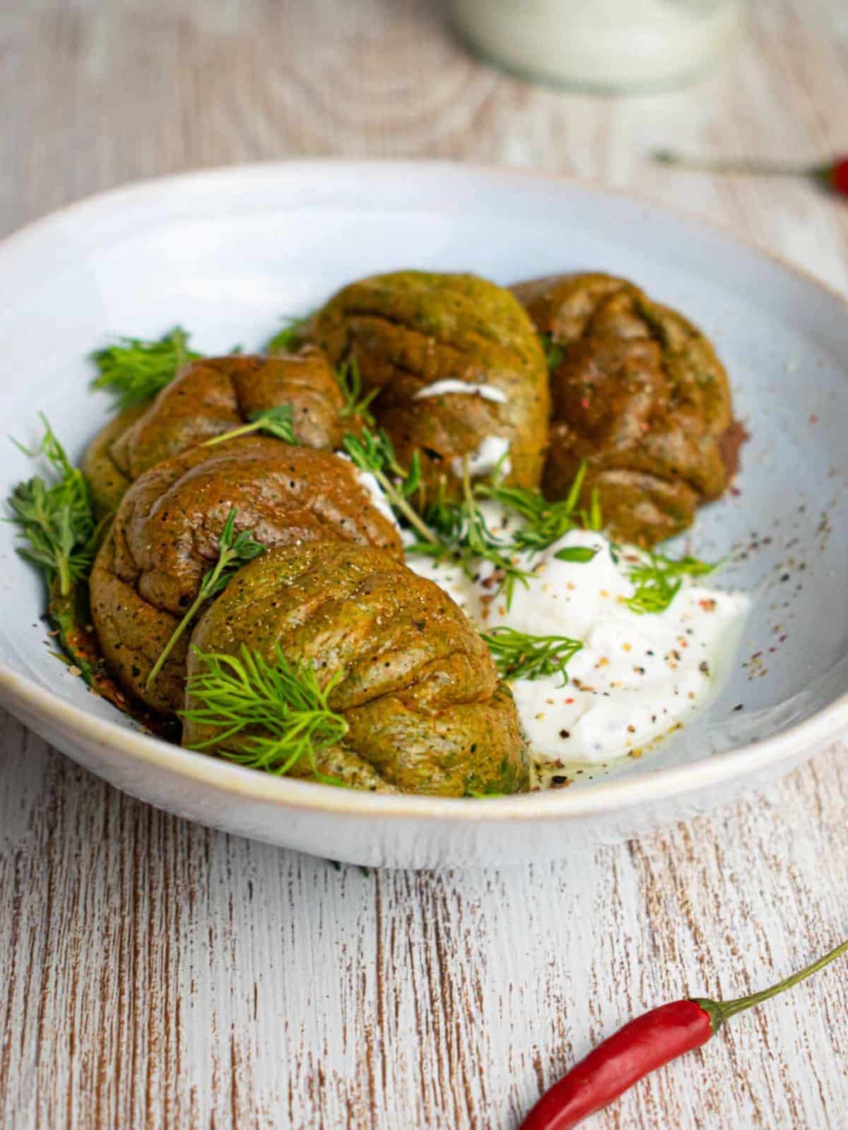 Spinach cheese egg bites on plate with yogurt dip.