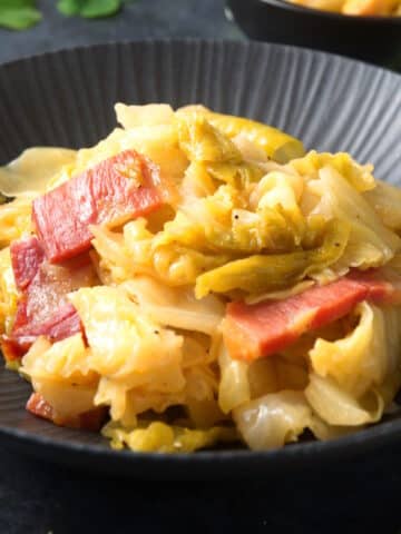 Cabbage and bacon in bowl.