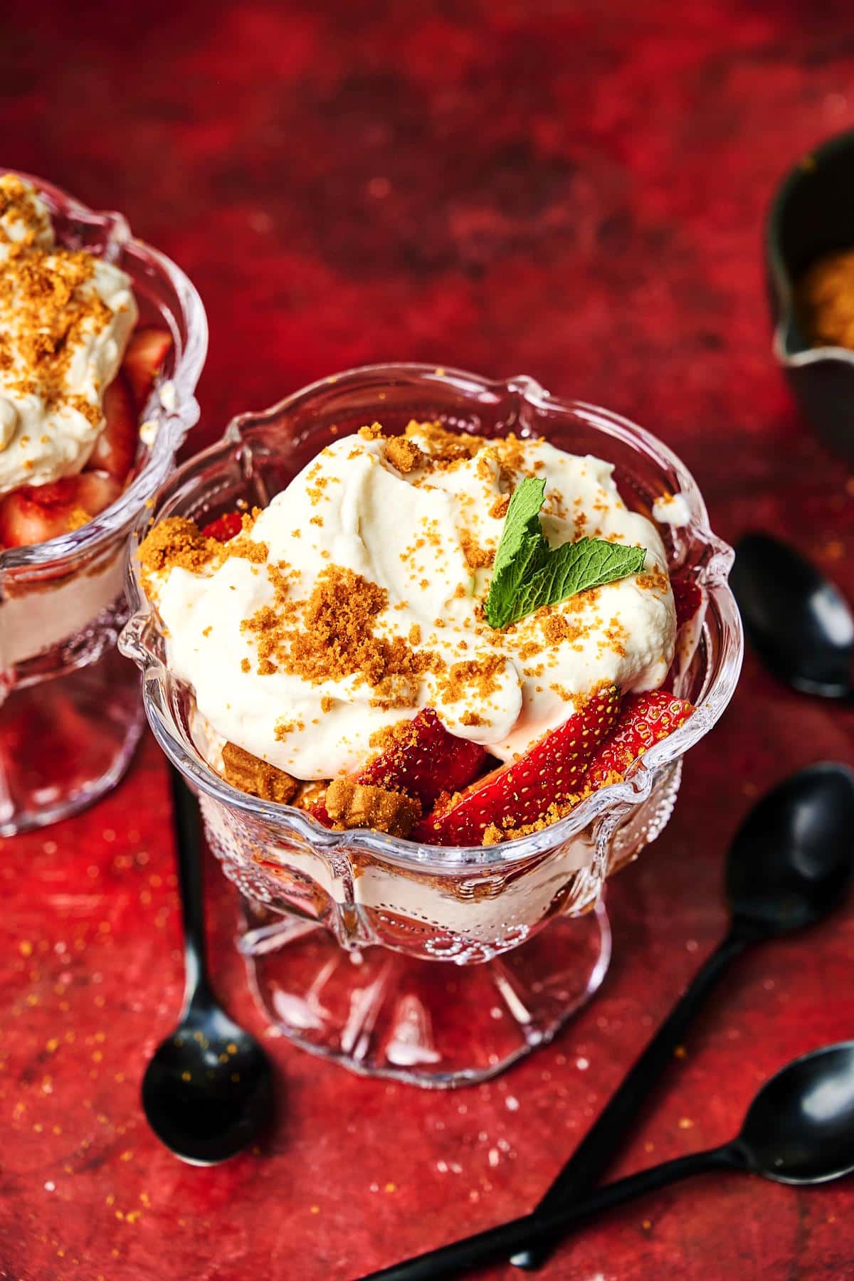 Strawberry parfait in glass with crushed Biscoff biscuits.