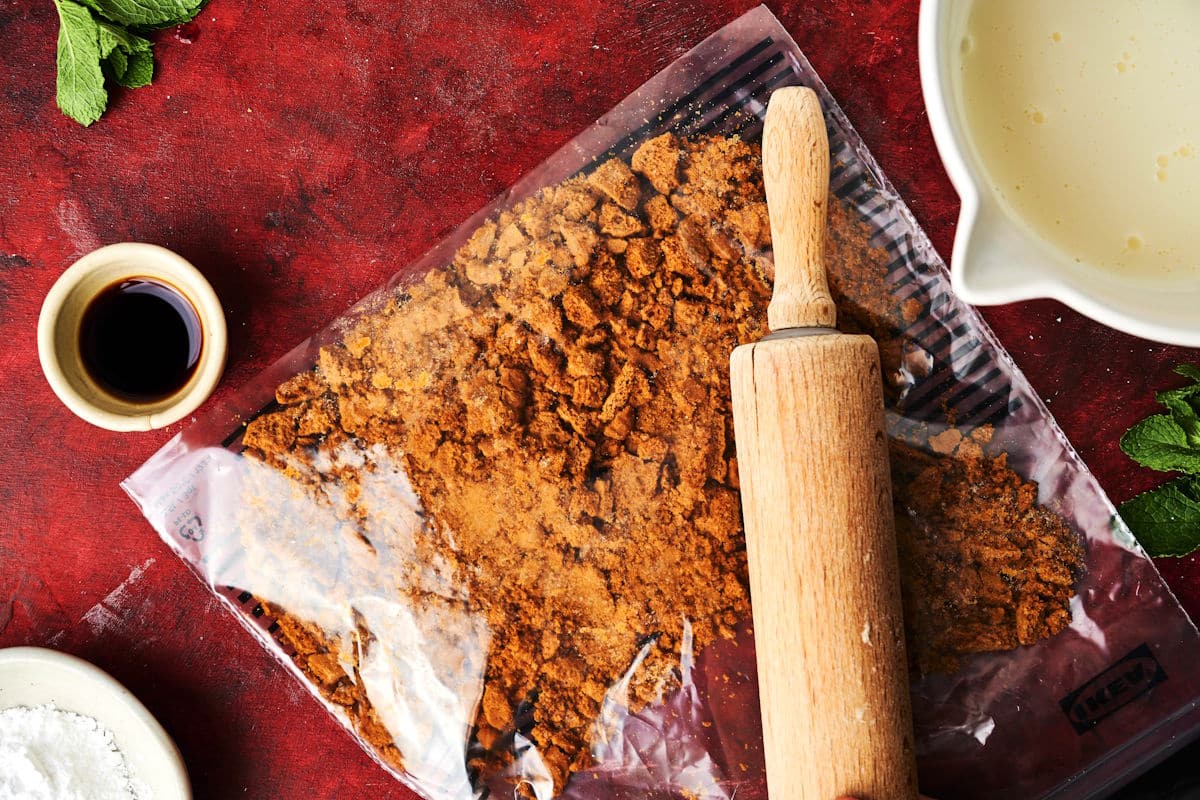 Rolling pin over bag of Biscoff biscuits.