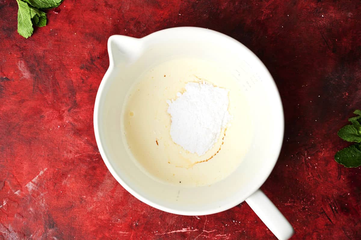 Heavy cream and sugar in bowl.