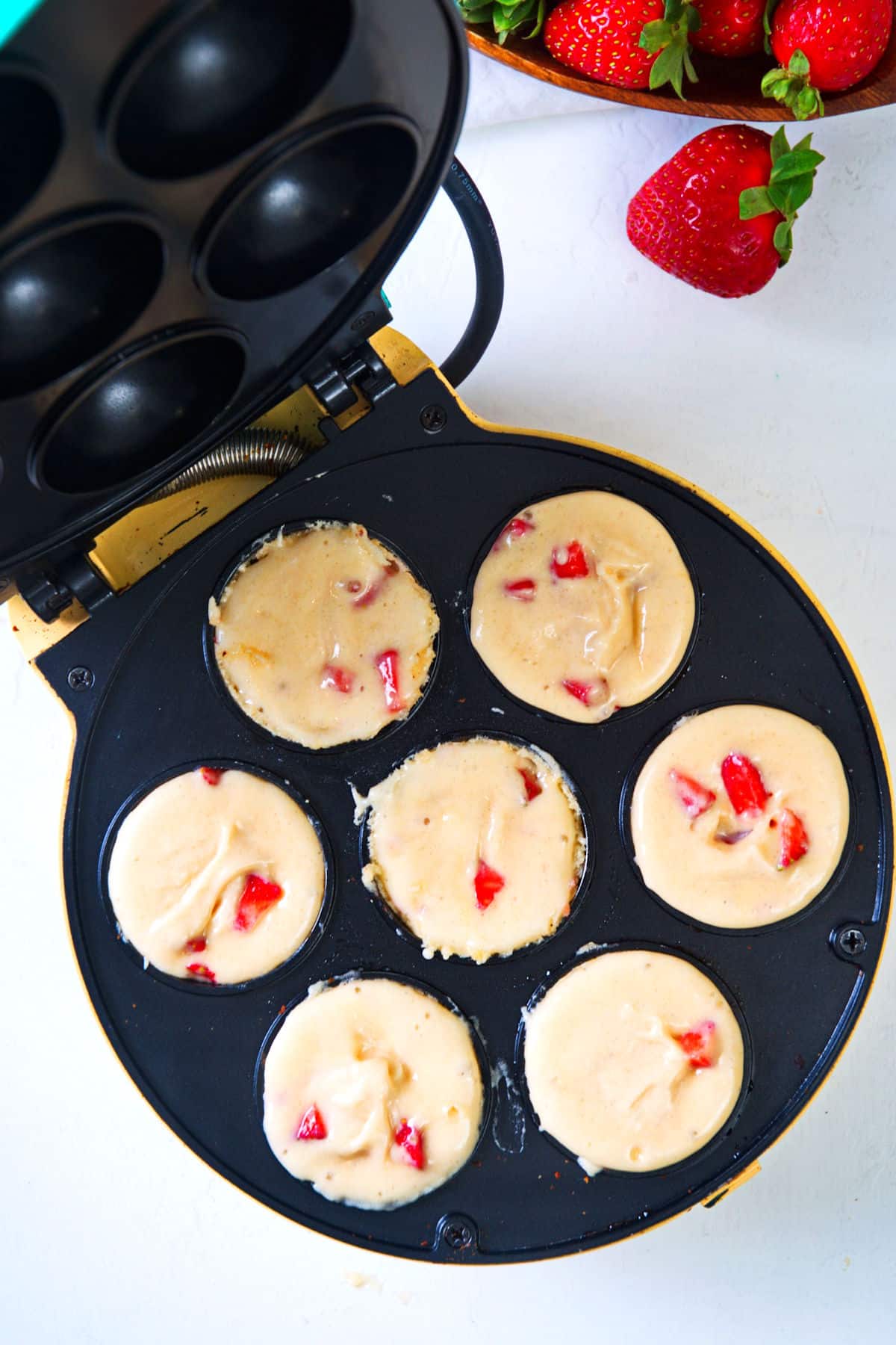 Strawberry shortcake batter in cake pop maker.