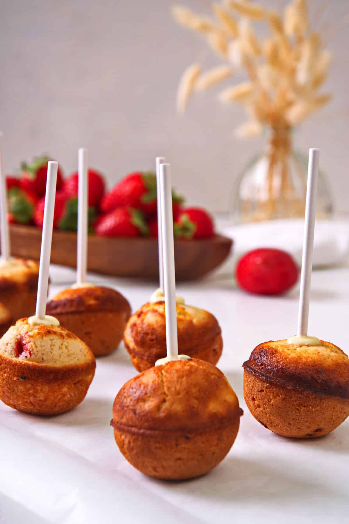 Strawberry shortcake cake balls on treat sticks.