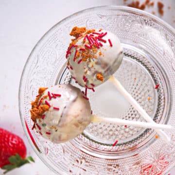 Strawberry shortcake pops with sprinkles and white chocolate coating.