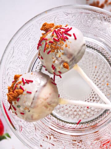 Strawberry shortcake pops with sprinkles and white chocolate coating.