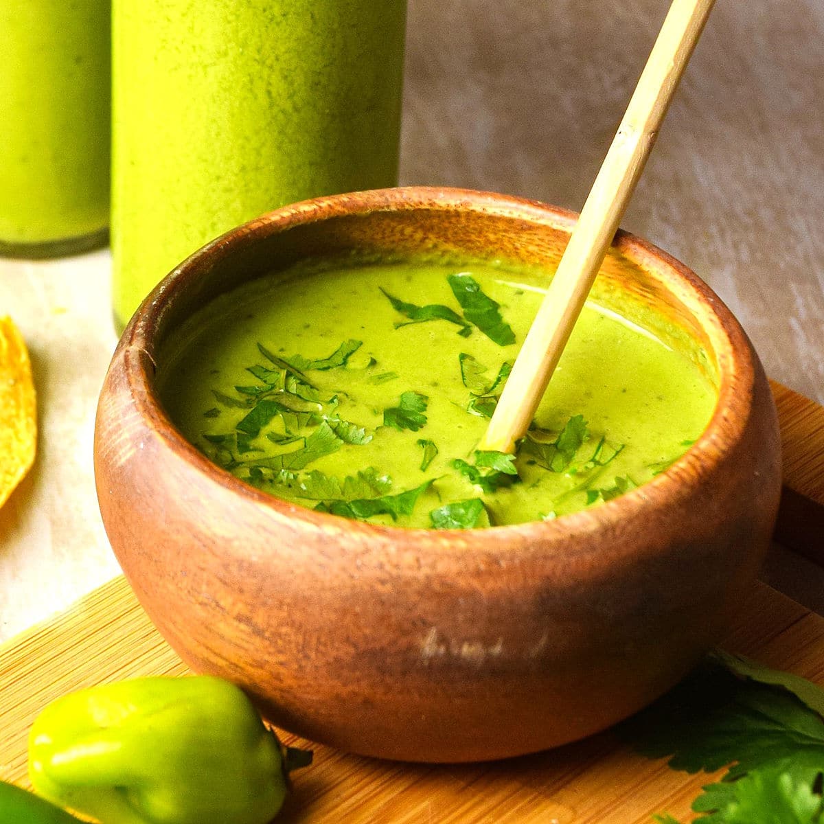 Tomatillo hot sauce in a small wooden bowl.