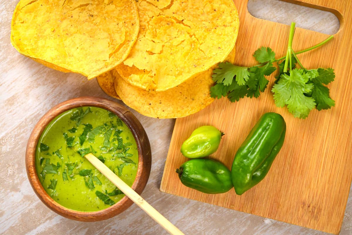Tomatillo hot sauce with jalapenos and tortilla chips on the side.