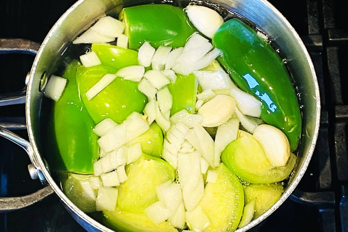 Tomatillo hot sauce ingredients in saucepan.