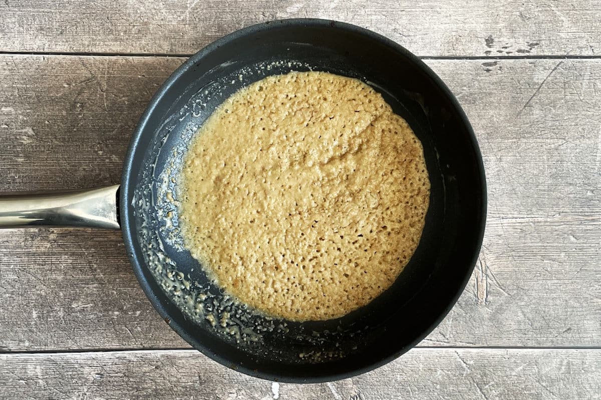 Golden tomato gravy roux in pan.