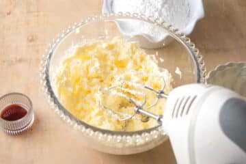 Frosting in bowl with hand mixer.